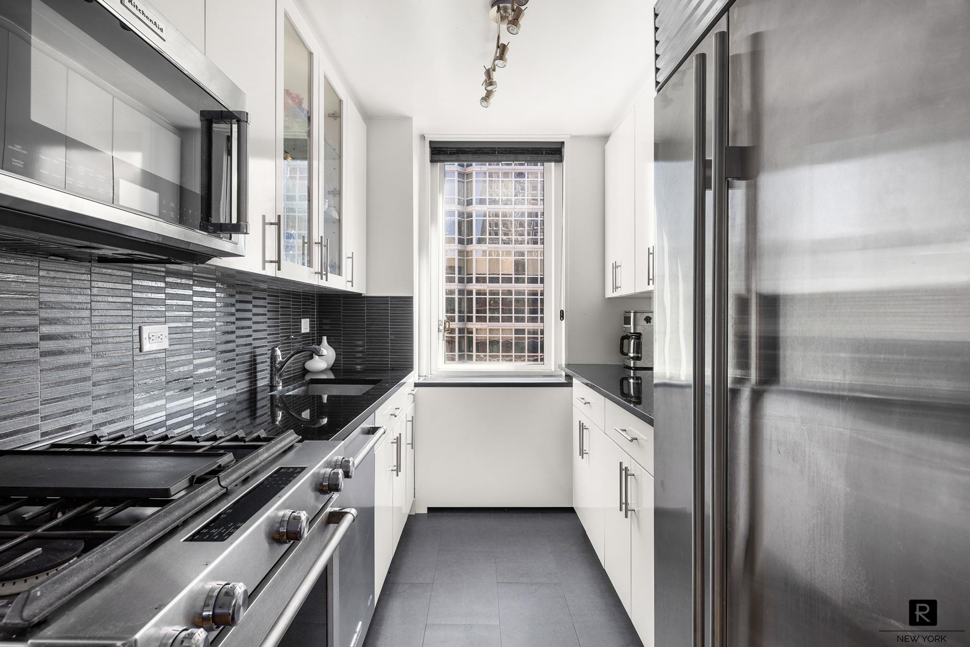 a kitchen with stainless steel appliances a sink and a stove