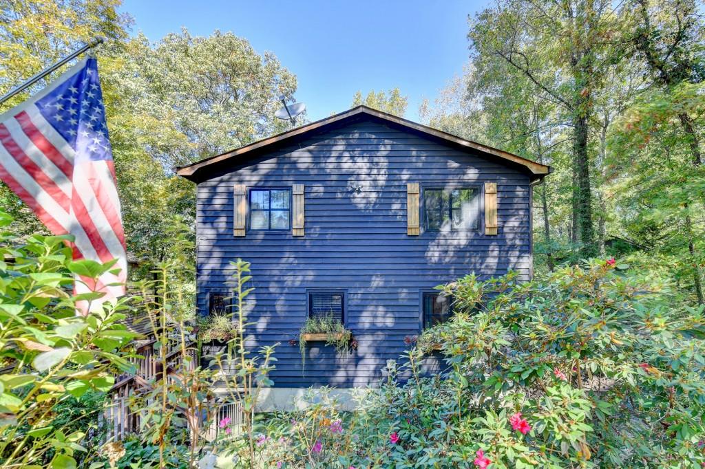 a view of a house with a yard and garden