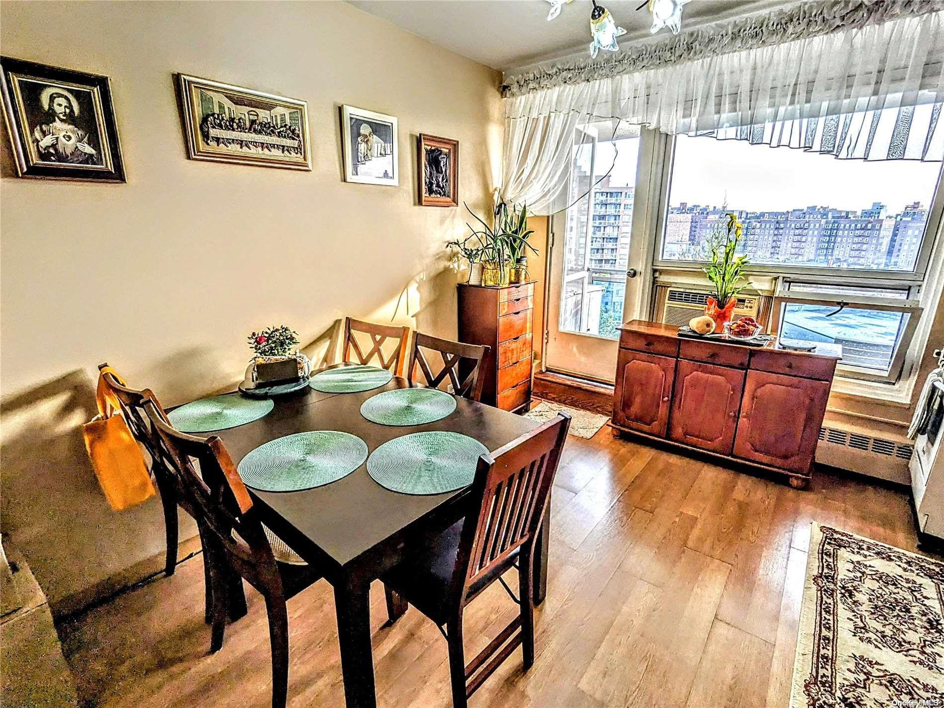 a view of a dining room with furniture a chandelier and wooden floor