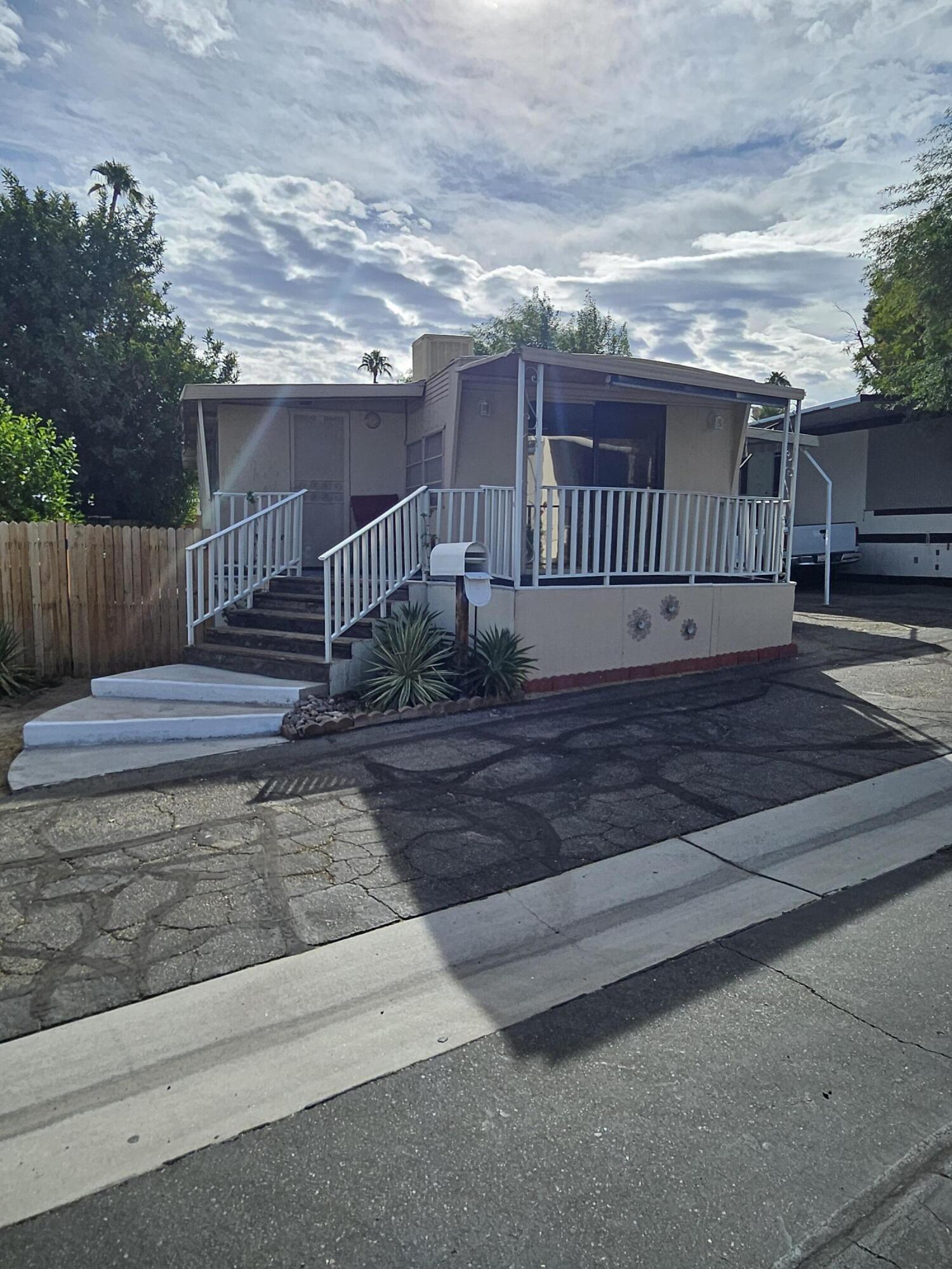 a view of a porch with wooden floor and fence