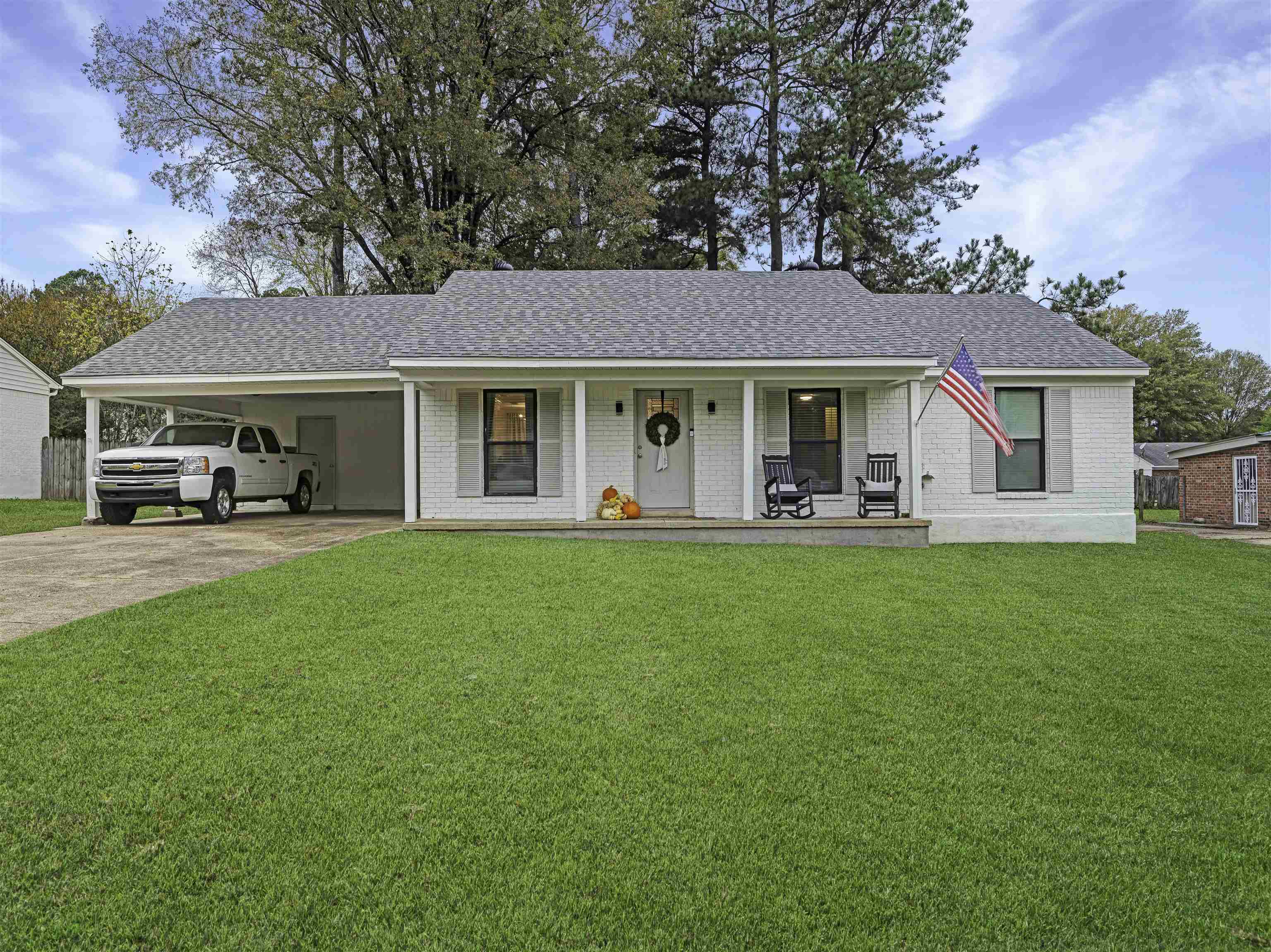 a view of a house with a yard porch and sitting area