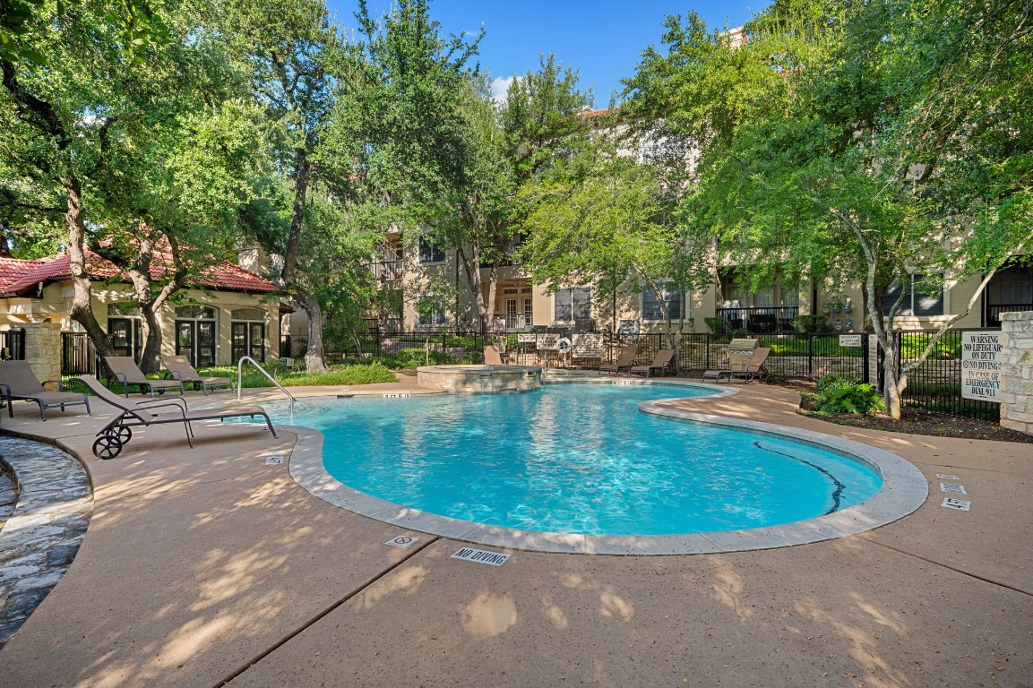 a view of a swimming pool with outdoor seating