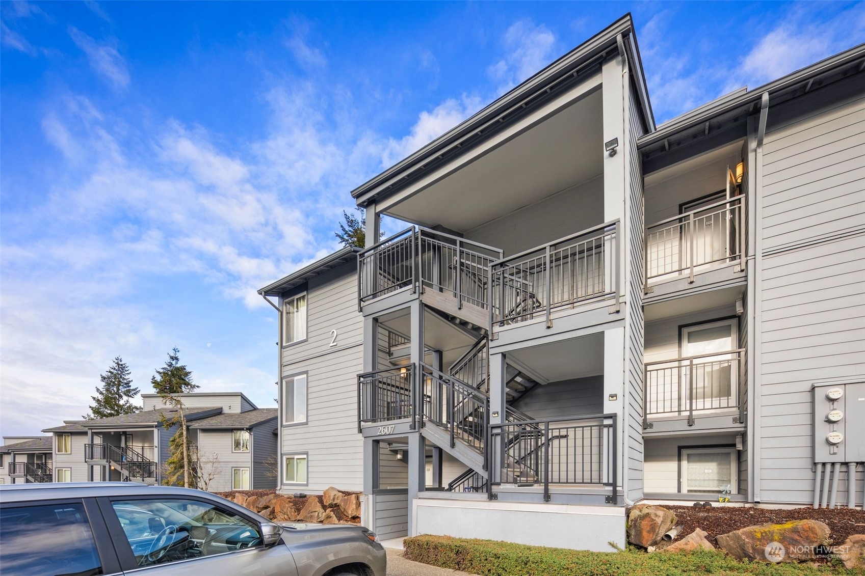 a front view of a house with parking space