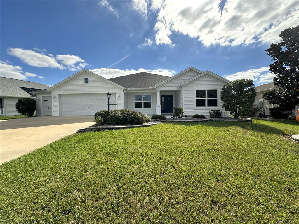 a front view of house with yard and green space