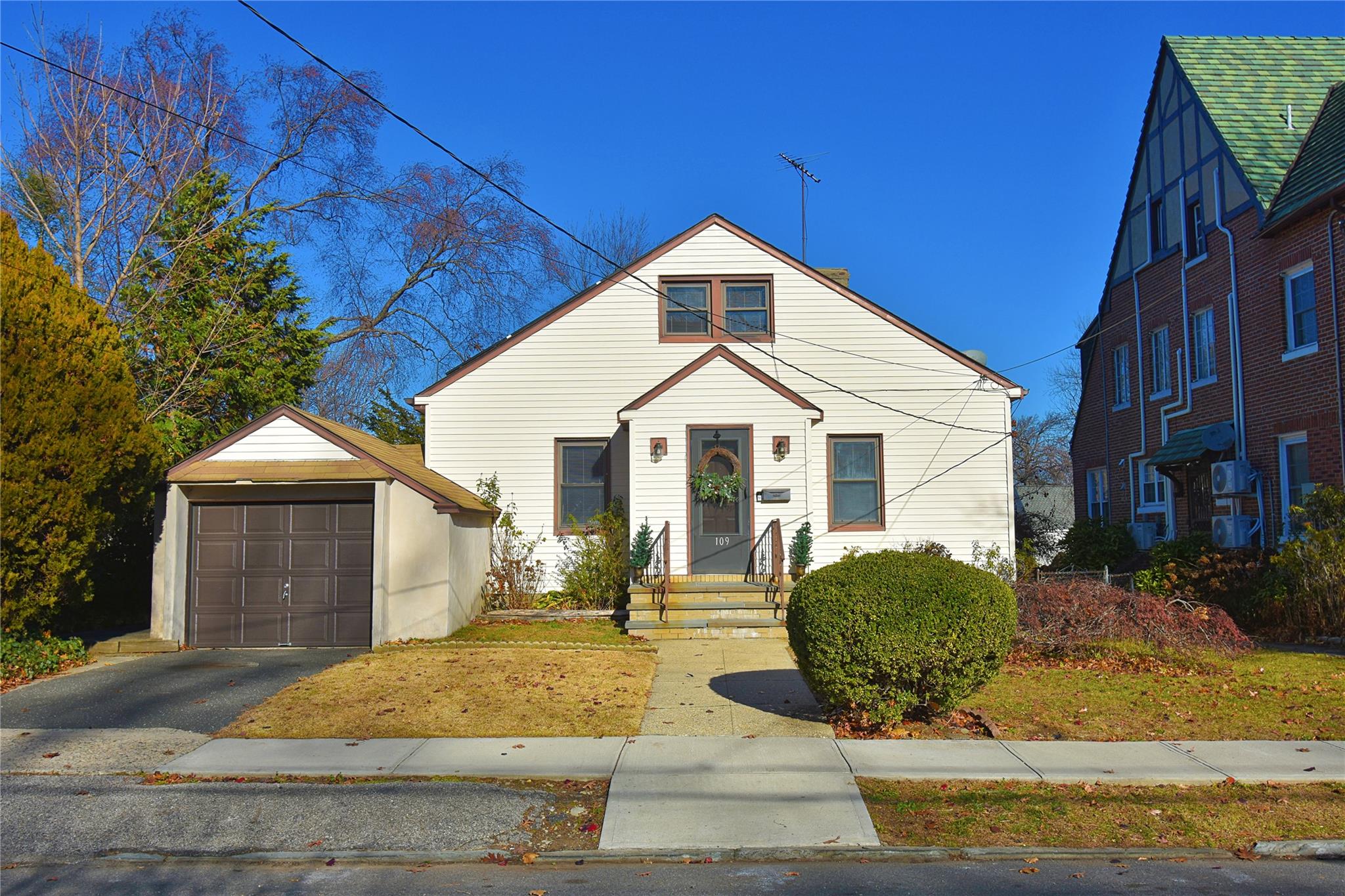 View of front of home with an outdoor structure and a garage