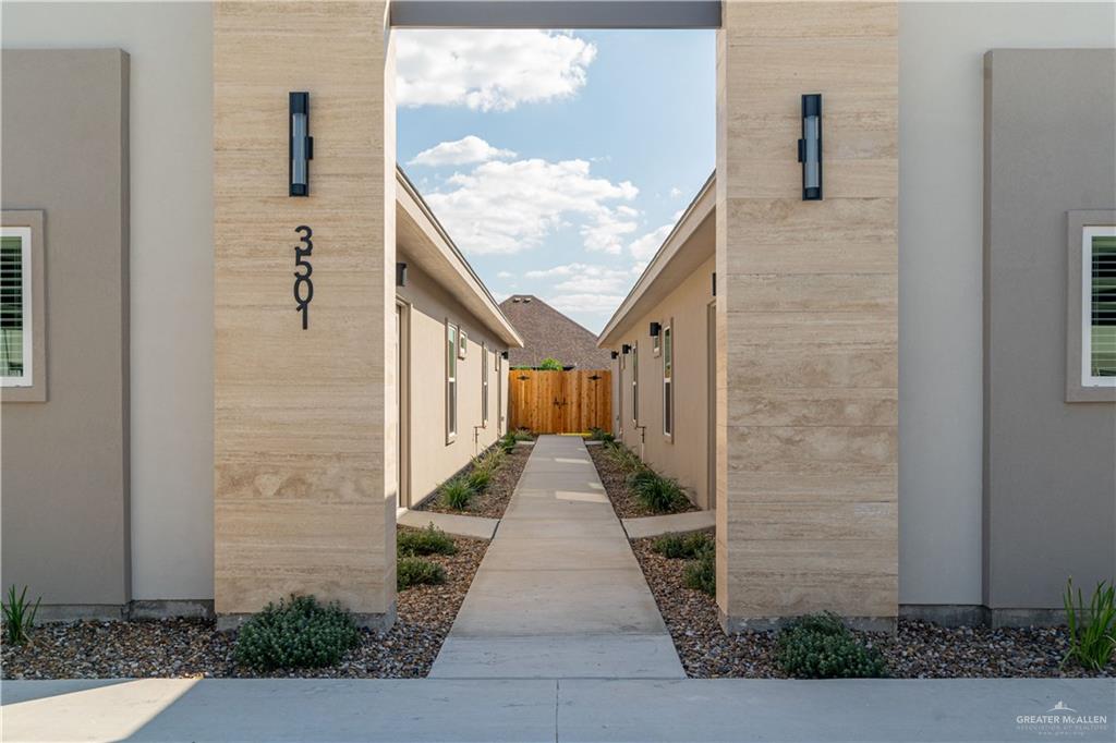 a pathway of a house with a yard