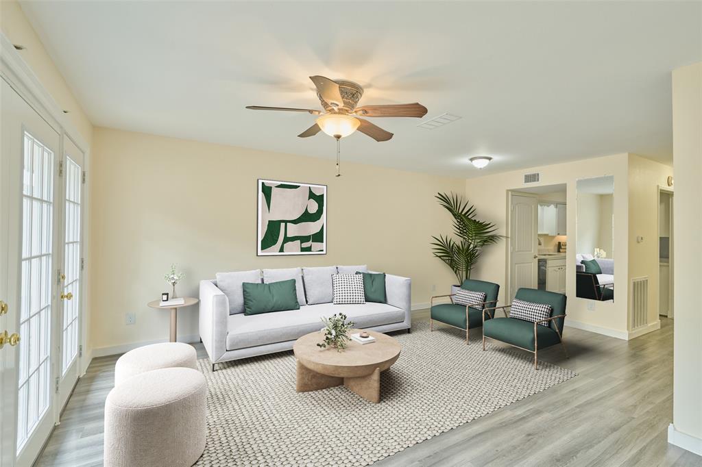 a living room with furniture and a chandelier