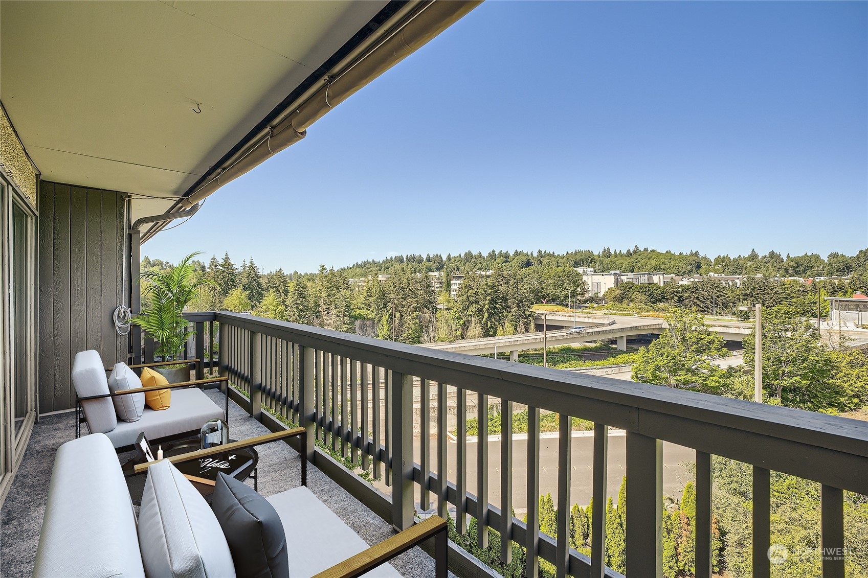 a view of a balcony with couches and wooden floor