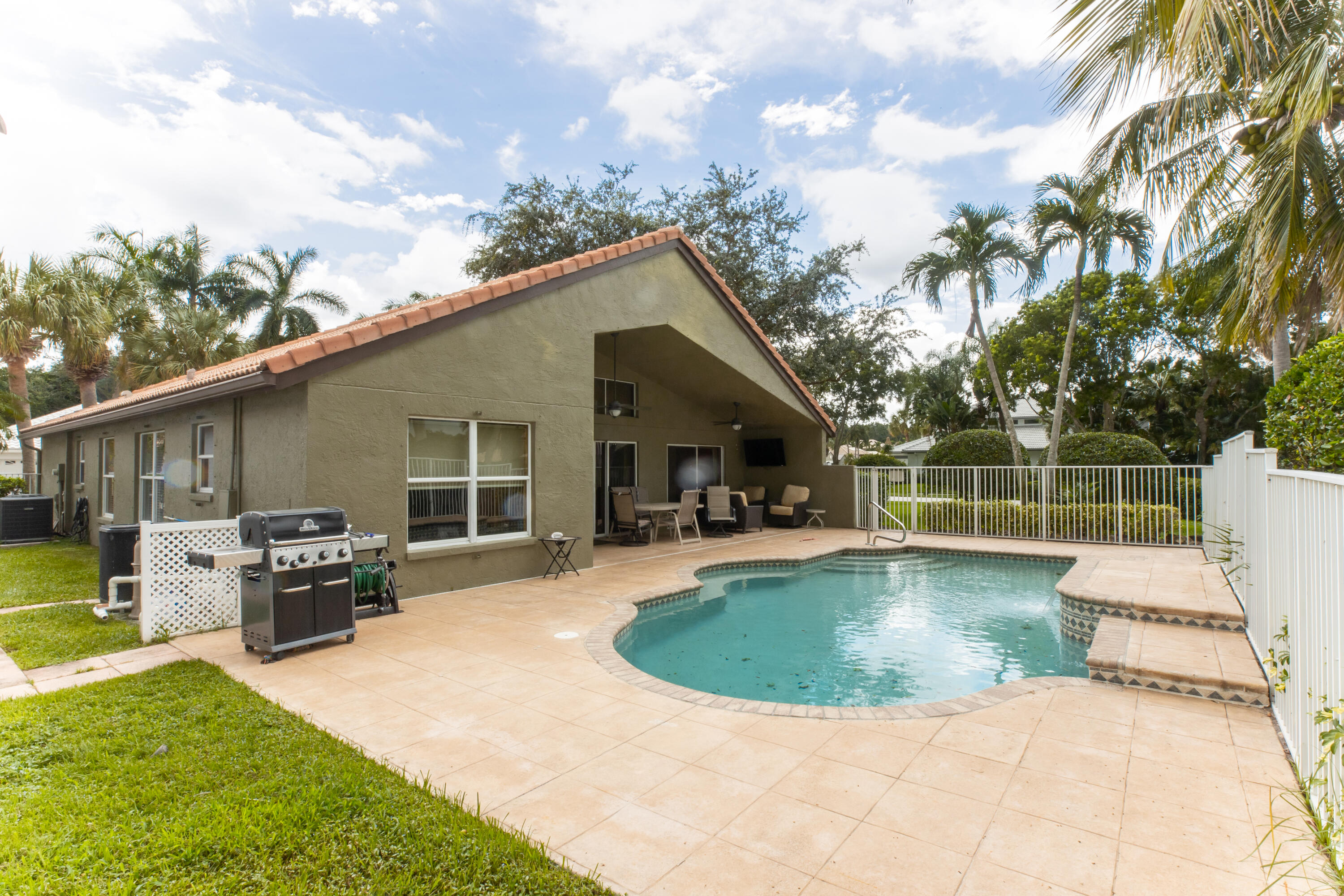 a view of a house with swimming pool and sitting area