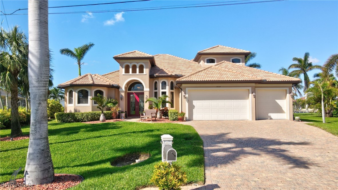 a front view of a house with a yard and garage