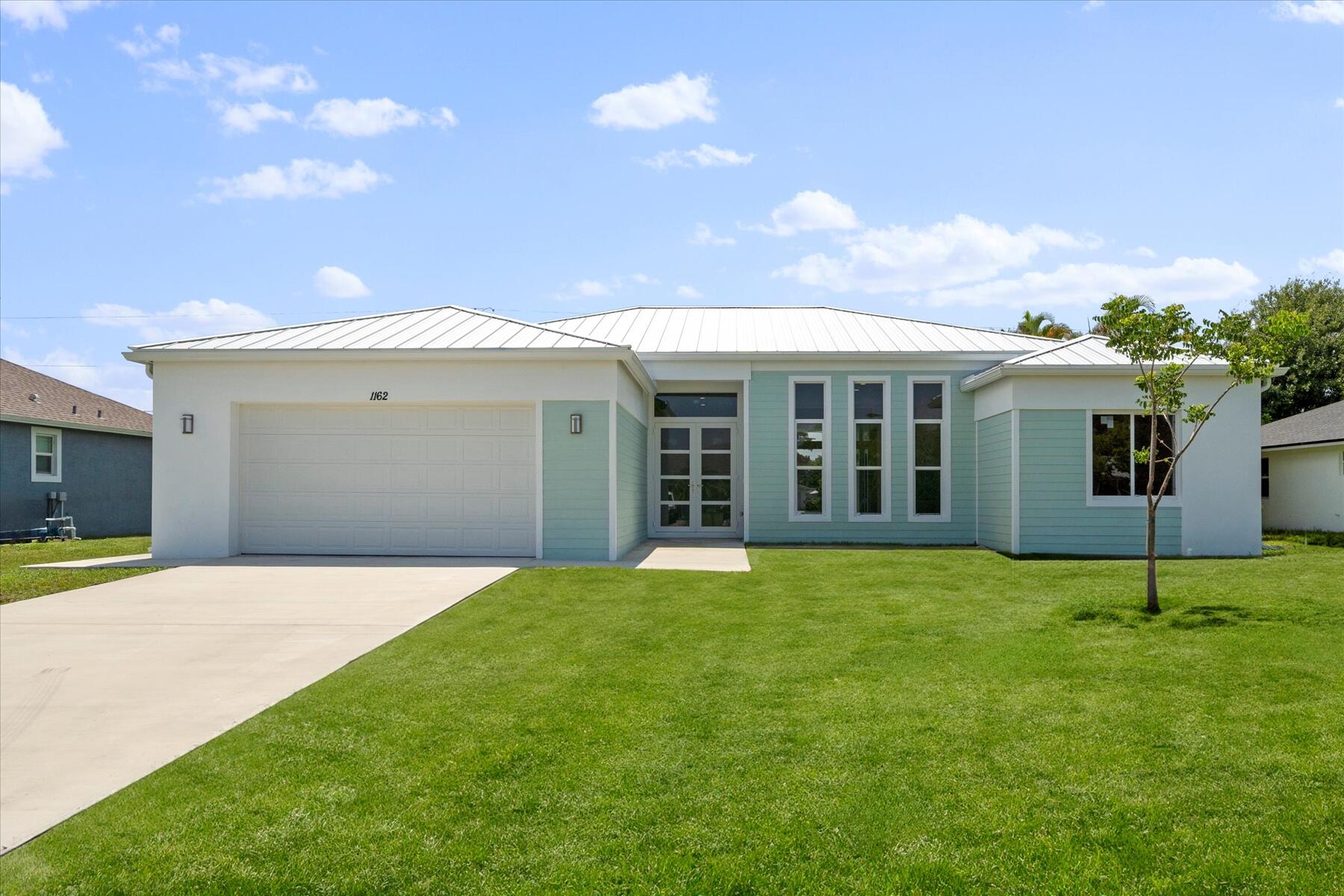 a front view of a house with a garden