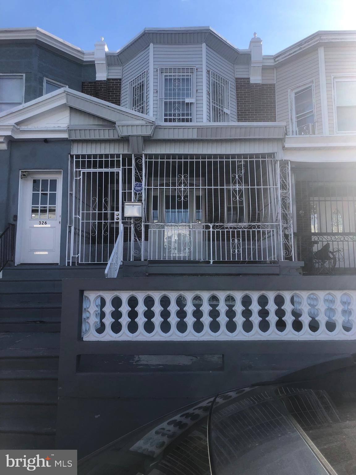 a view of a house with a wooden fence