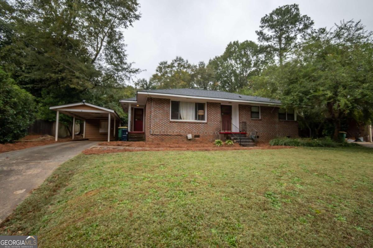 a front view of house with yard and trees