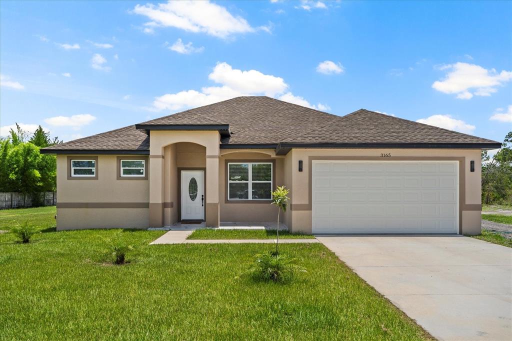 a front view of house with yard and green space