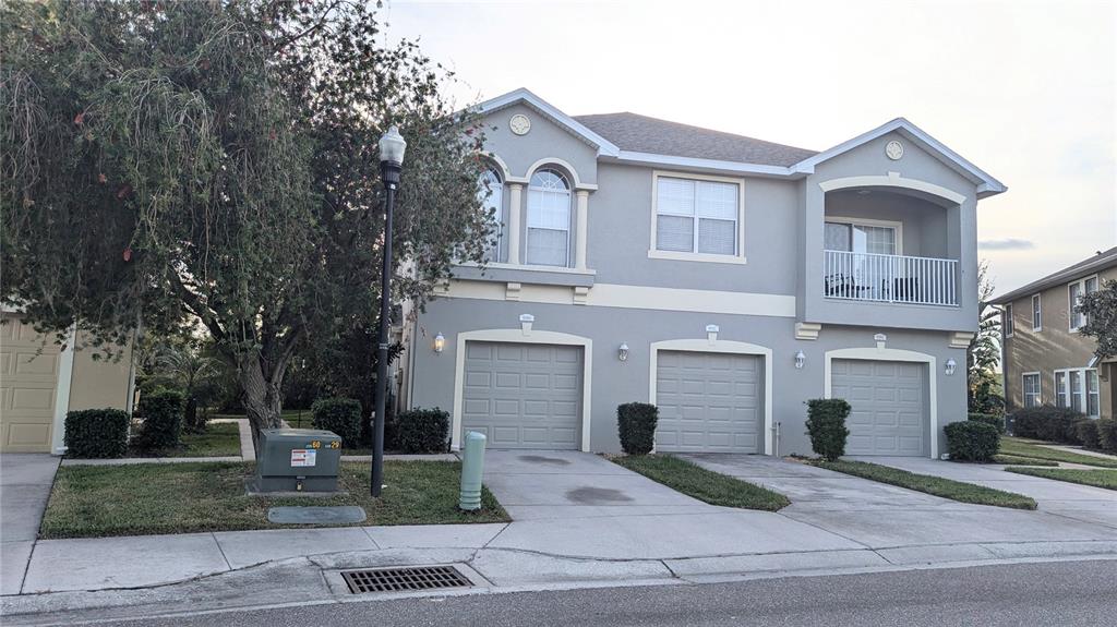 a front view of a house with a yard and garage