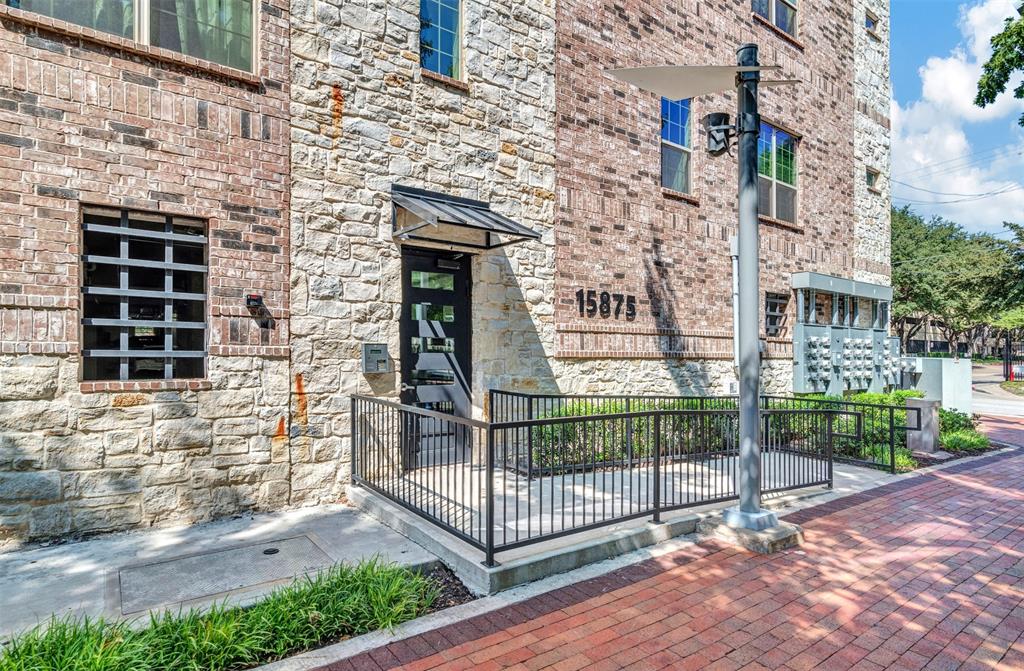 a view of front door and brick wall