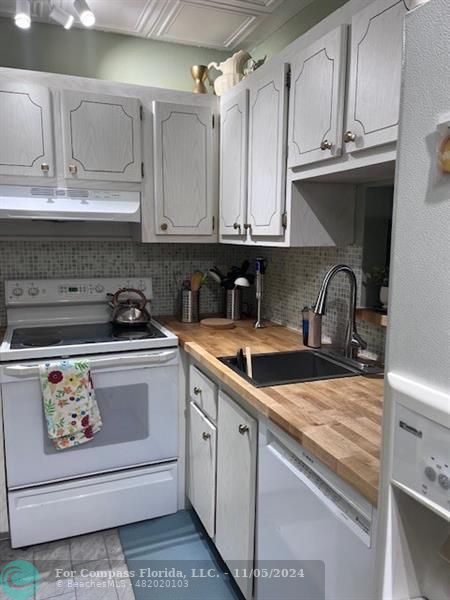 a kitchen with granite countertop a sink and cabinets