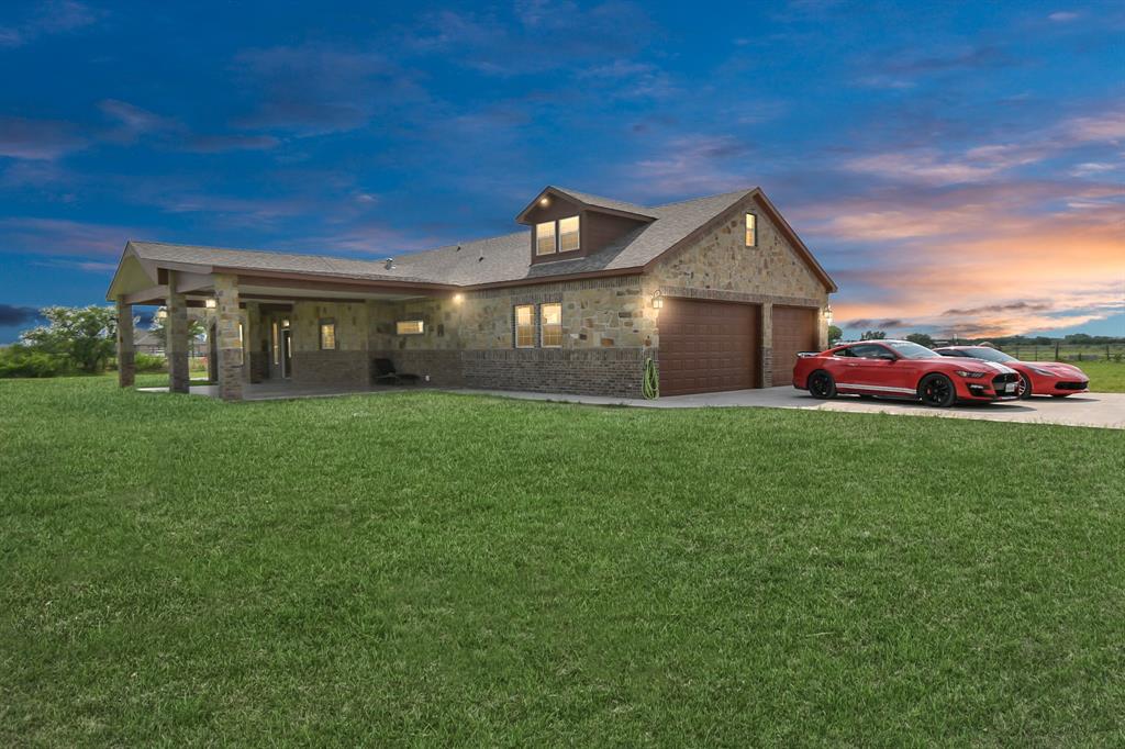 a front view of a house with a yard and garage