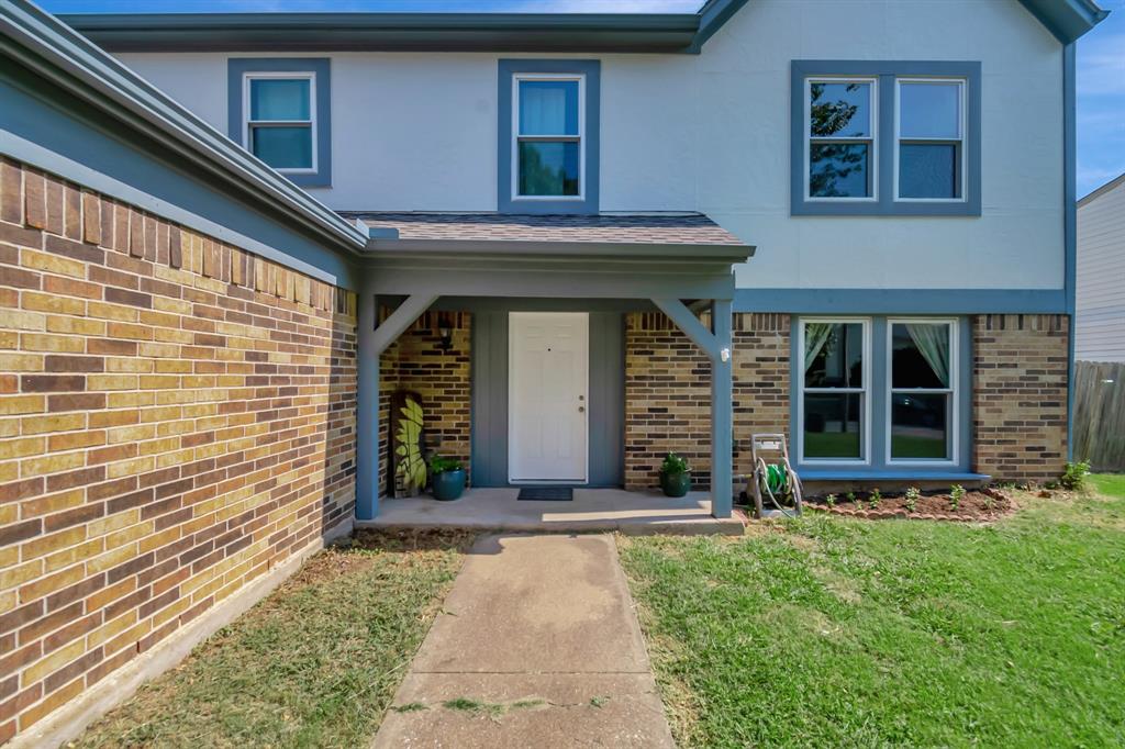 a view of front door of house with yard