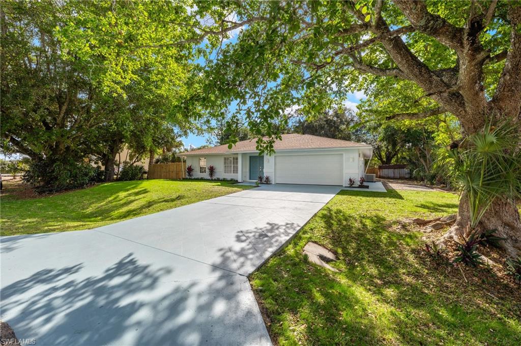 Single story home with a front lawn and a garage