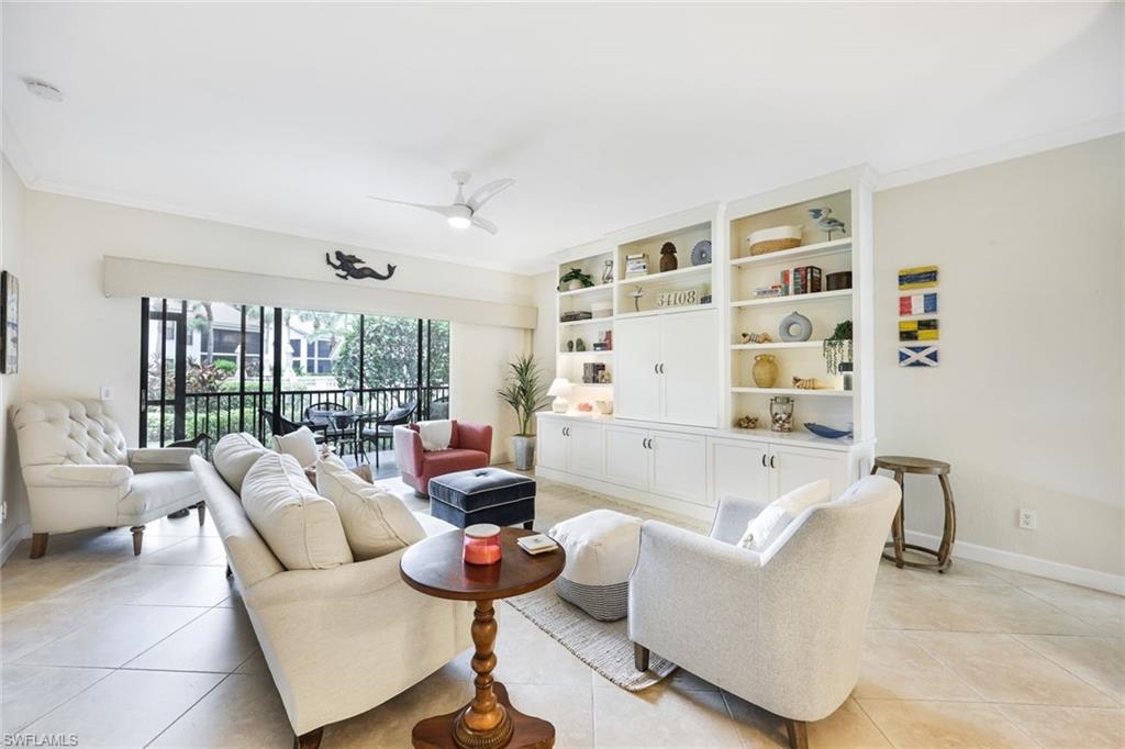 a living room with furniture and floor to ceiling window