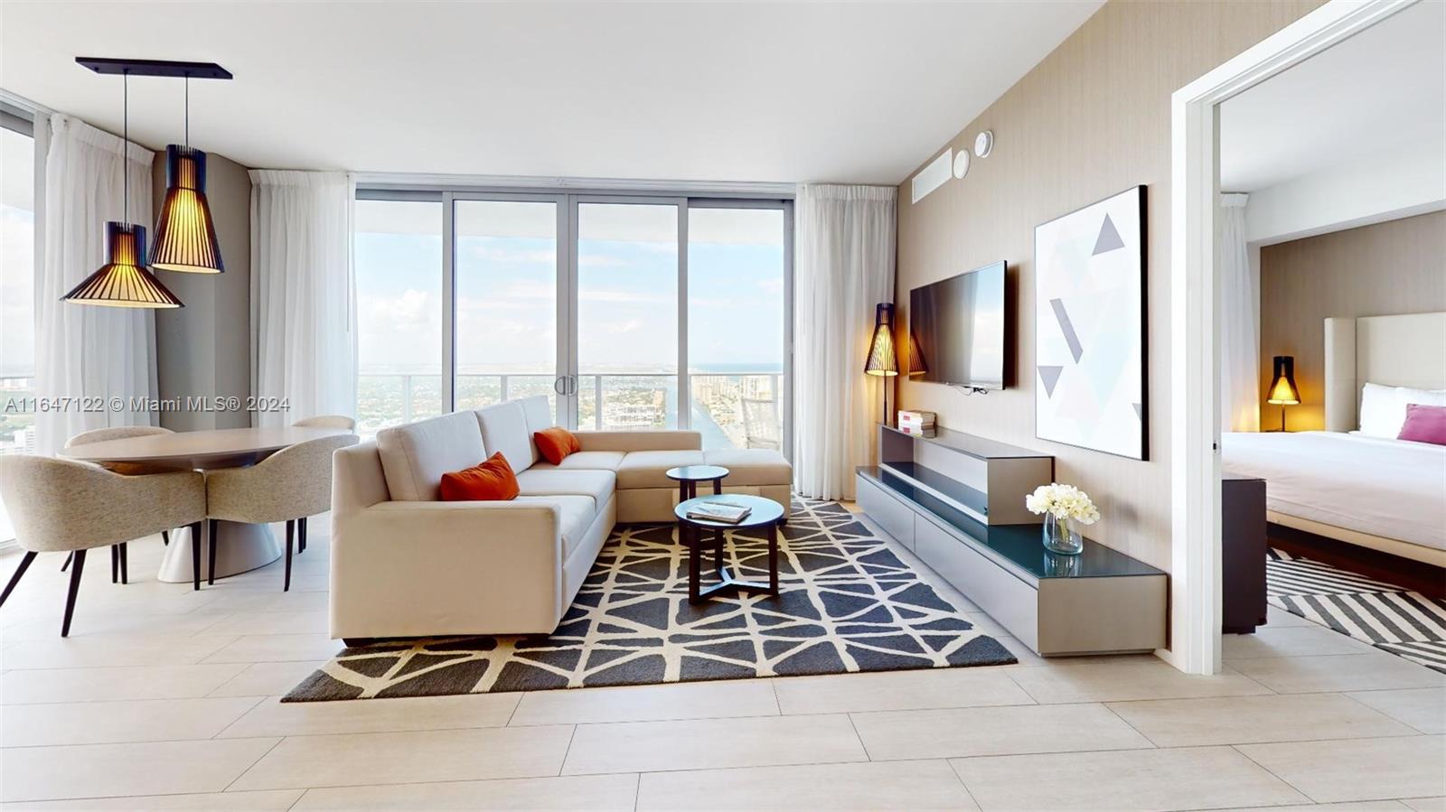 a living room with patio furniture and a flat screen tv