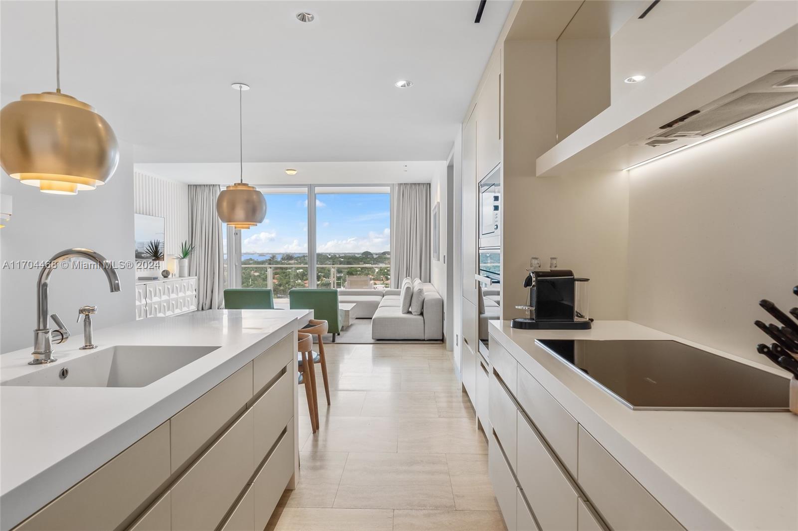 a kitchen with stainless steel appliances a sink a stove and a wooden floors