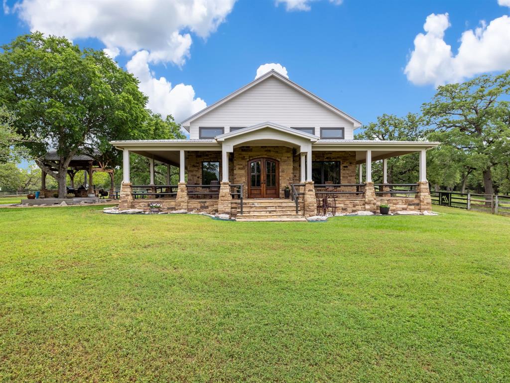 a front view of house with yard and outdoor seating