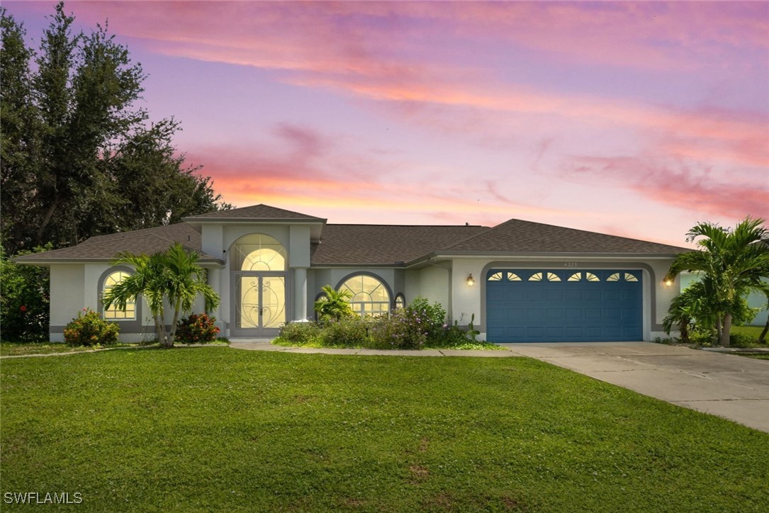 a front view of house with yard and green space