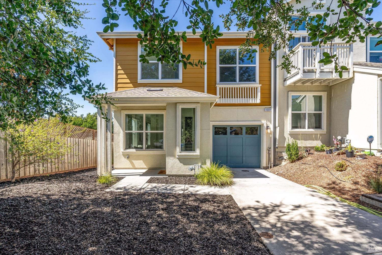 a front view of a house with a yard and seating space