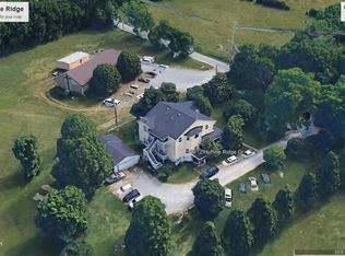 an aerial view of a house with outdoor space and lake view