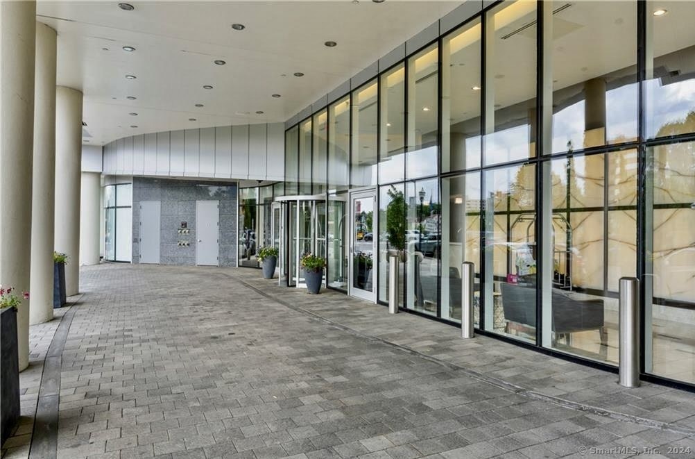 a view of an entryway with floor to ceiling window and stairs