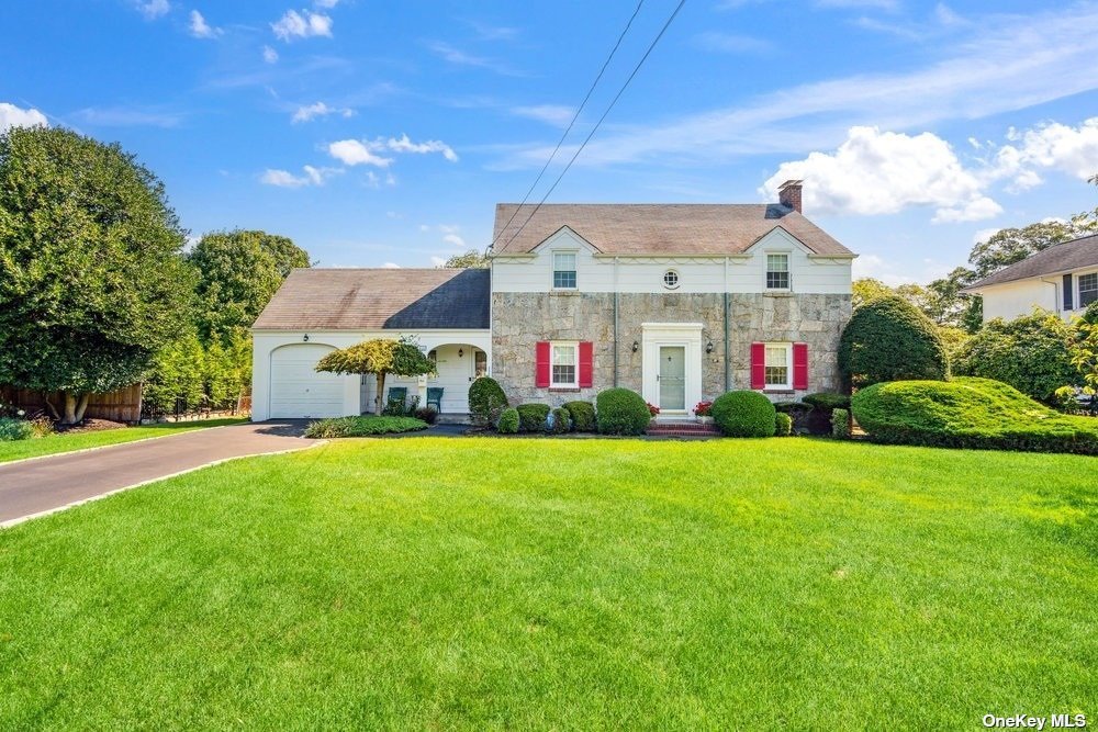 a front view of house with yard and outdoor seating