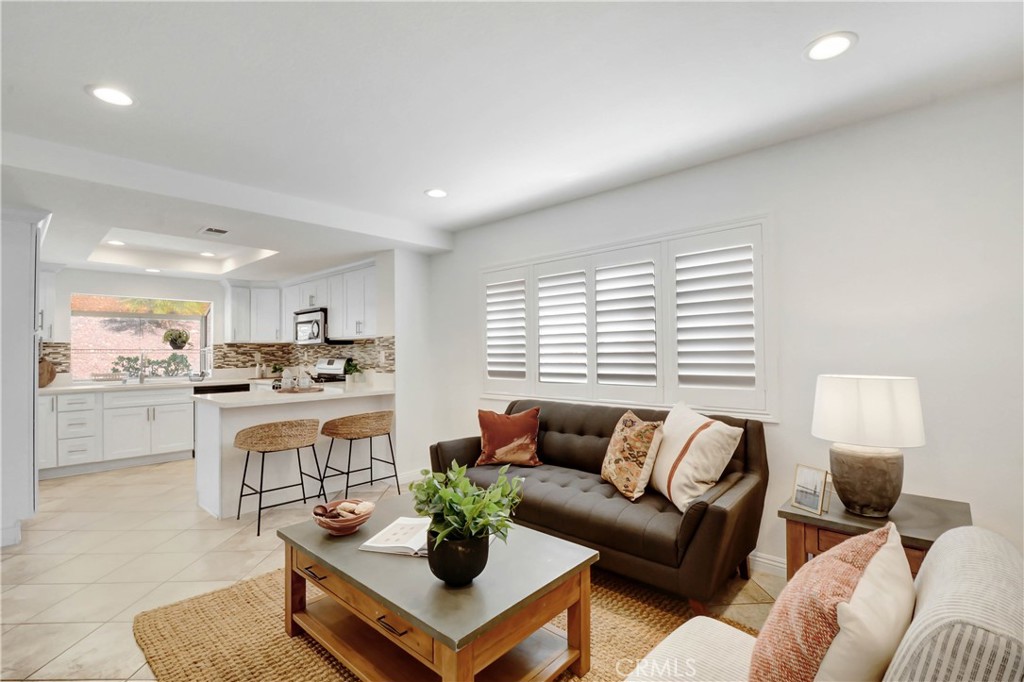 a living room with furniture and view of kitchen