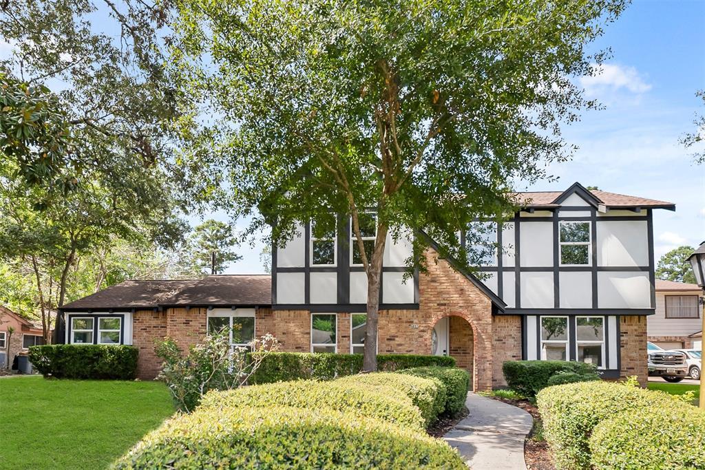 front view of a house with a tree