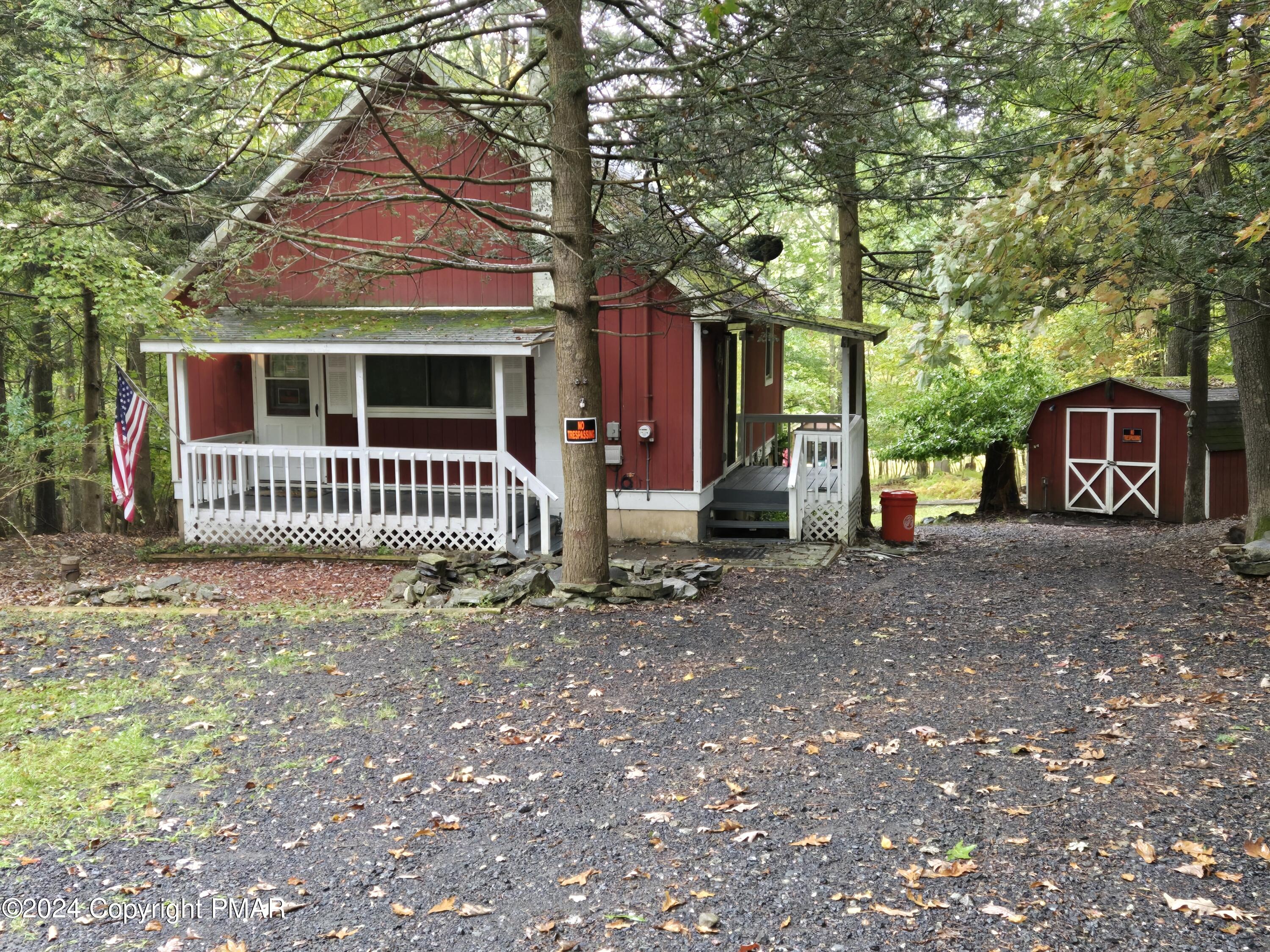 a view of a house with a yard and tree s