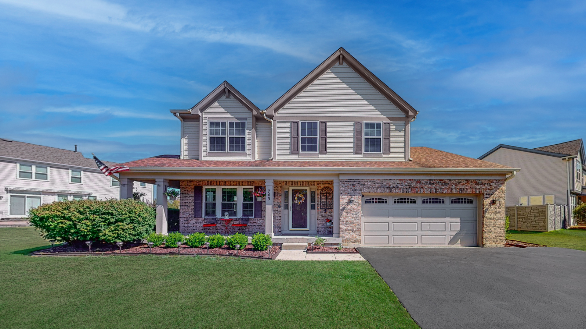 front view of brick house with a yard