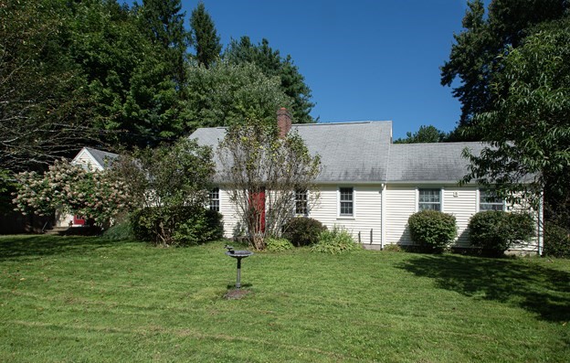 a view of a house with a backyard