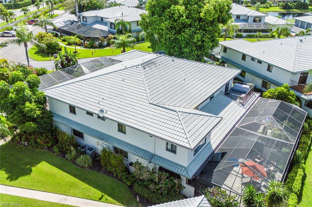 an aerial view of a house with a yard and potted plants