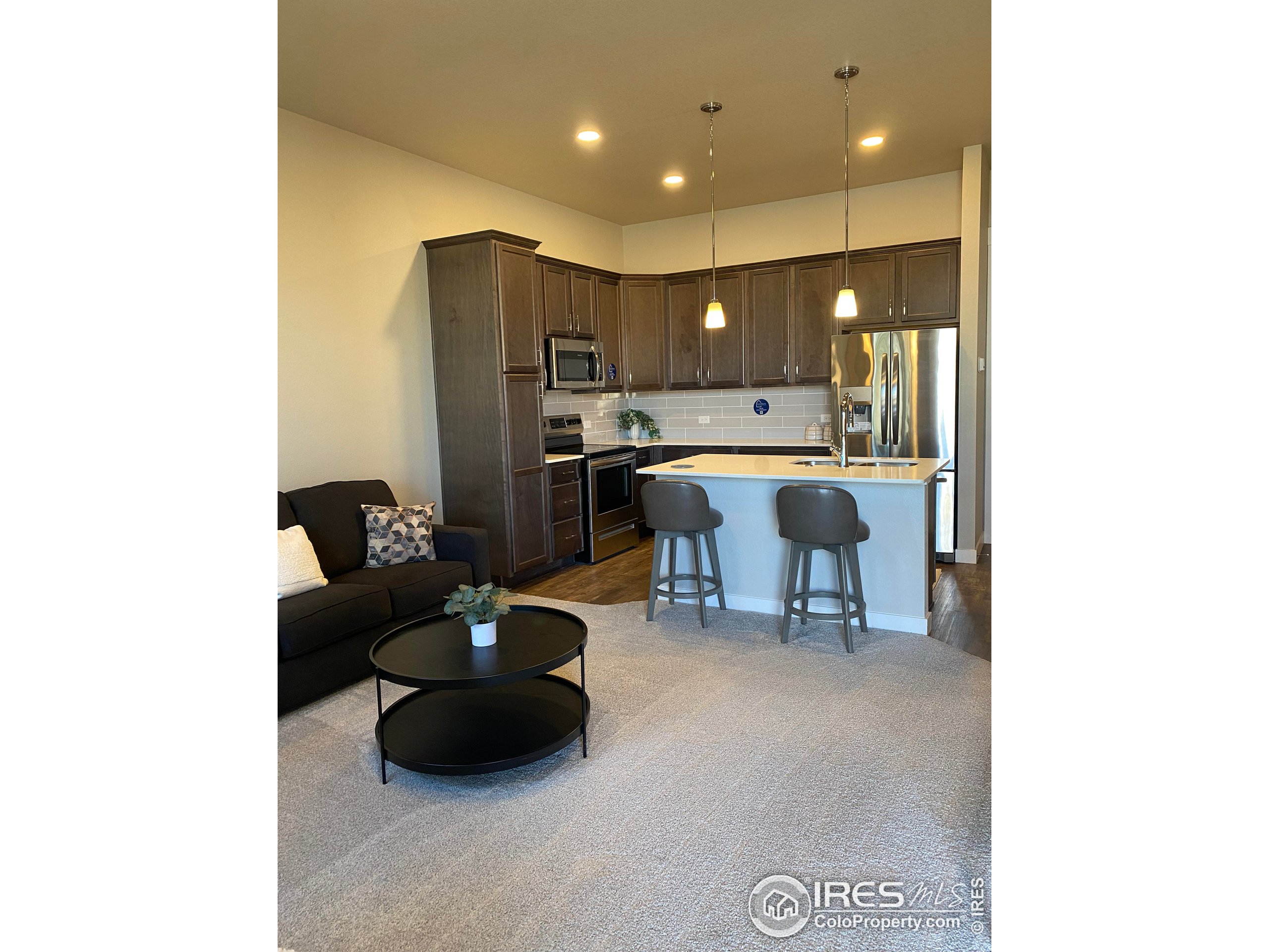 a living room with a couch and a dining table