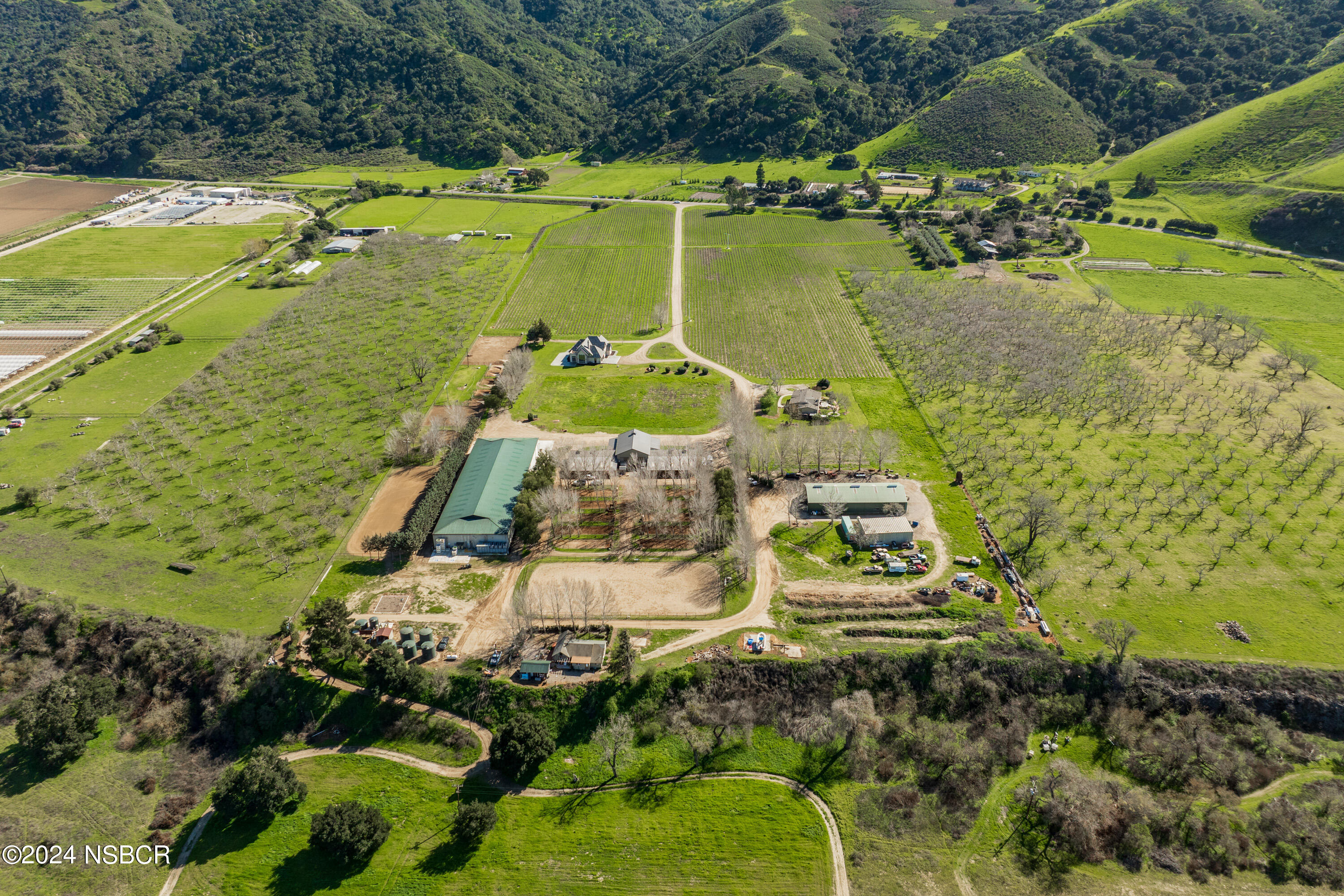 an aerial view of a house with a yard and lake view