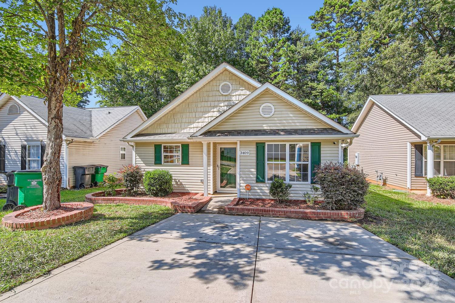 a front view of a house with a yard and outdoor seating