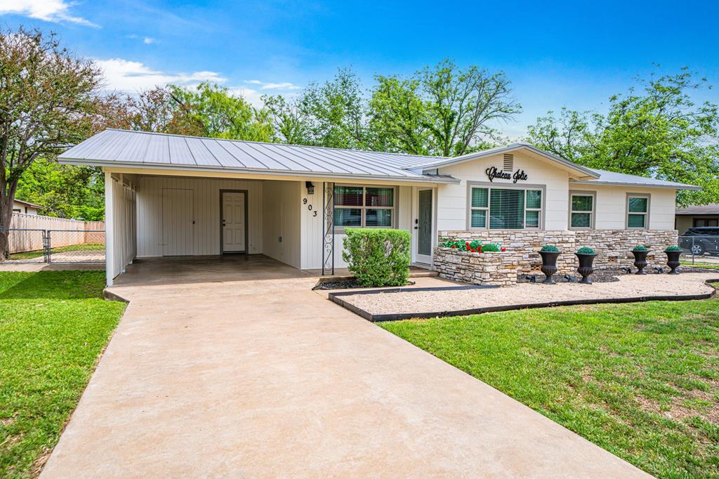 a front view of house with yard and green space