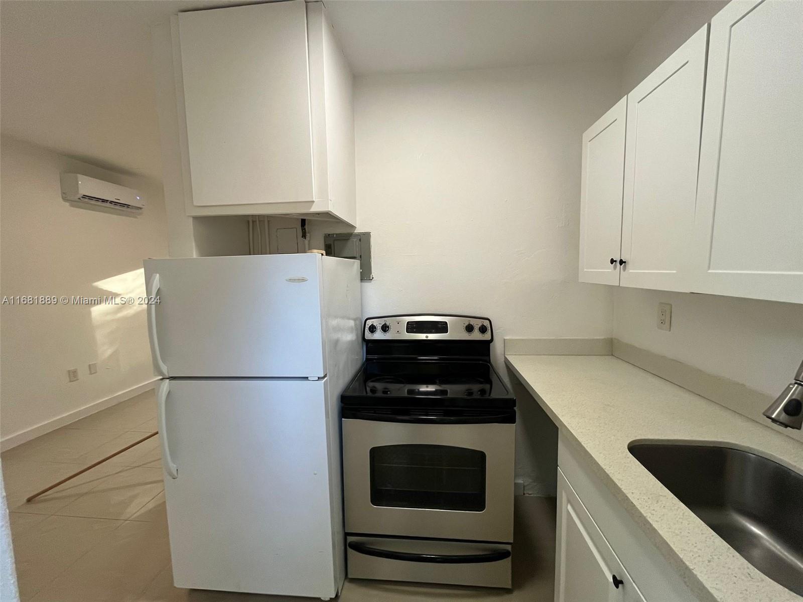 a kitchen with a refrigerator and a sink