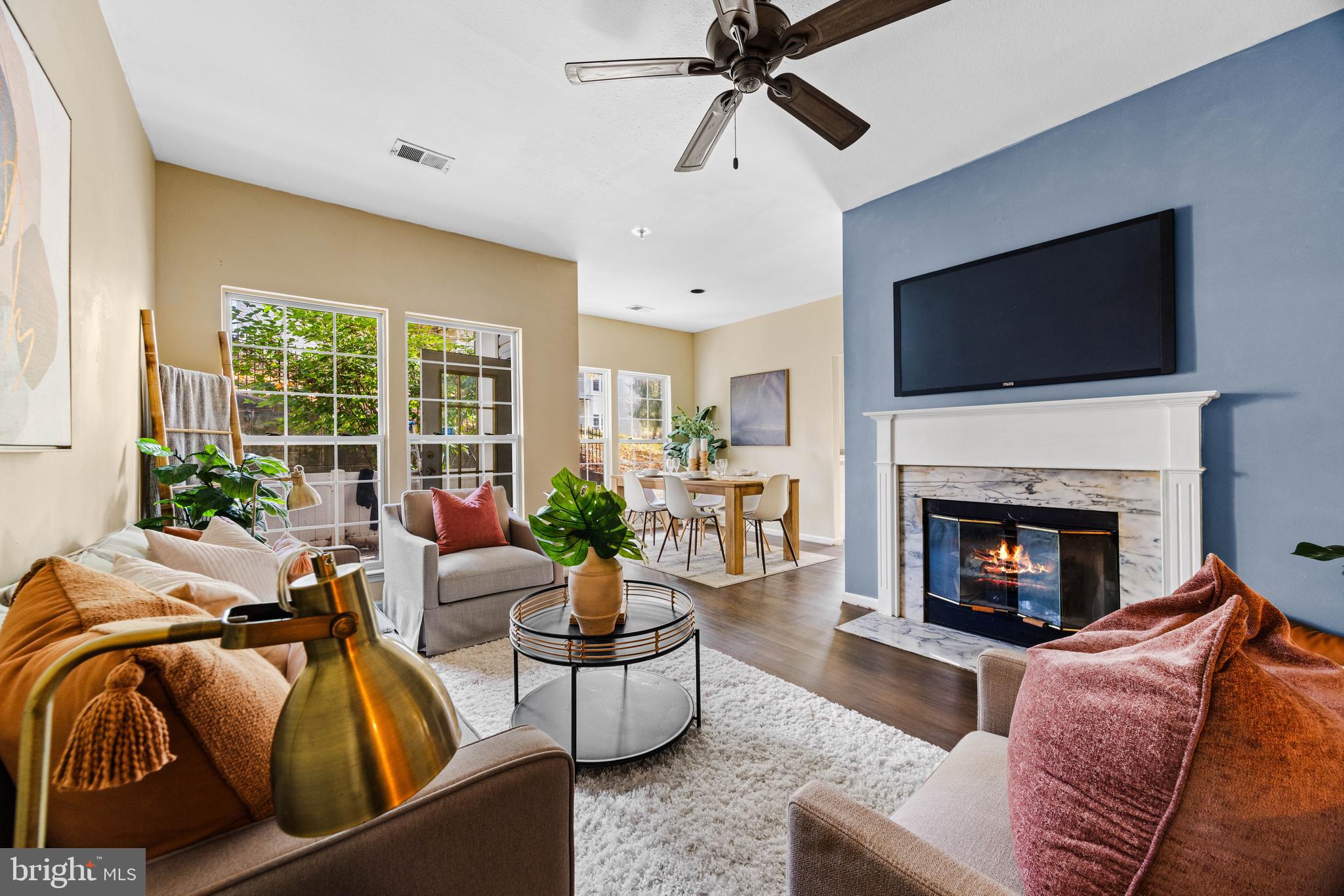 a living room with furniture a fireplace and a flat screen tv