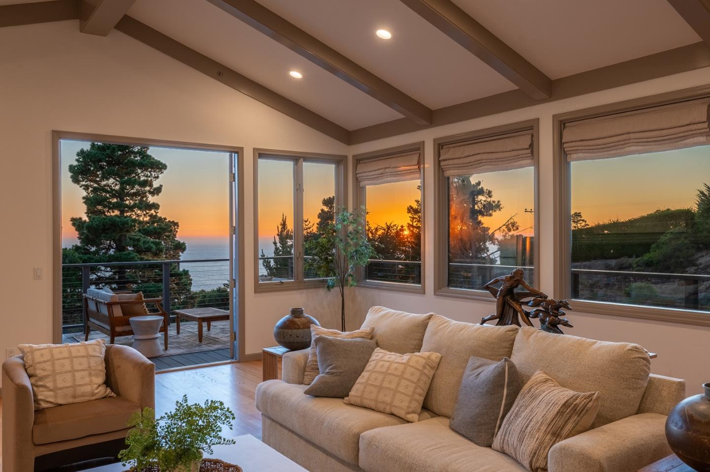 a living room with furniture and a floor to ceiling window