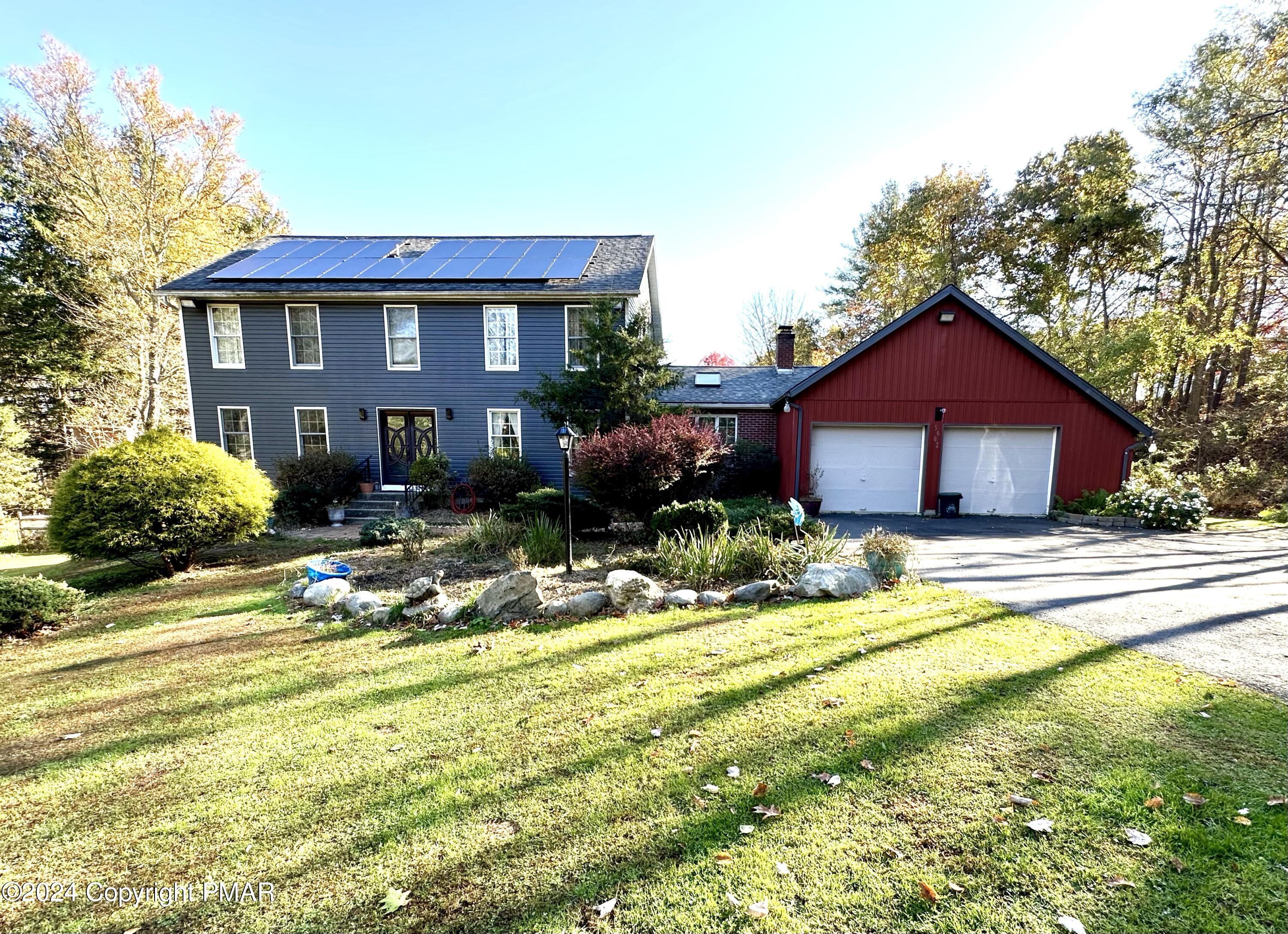 a view of a house with swimming pool and a yard