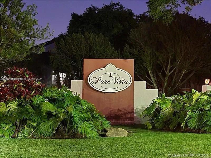 a view of a house with a backyard and garden