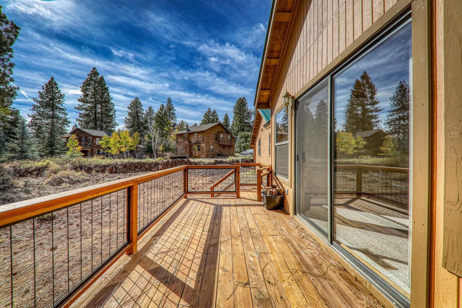 a view of balcony with a glass door and wooden floor