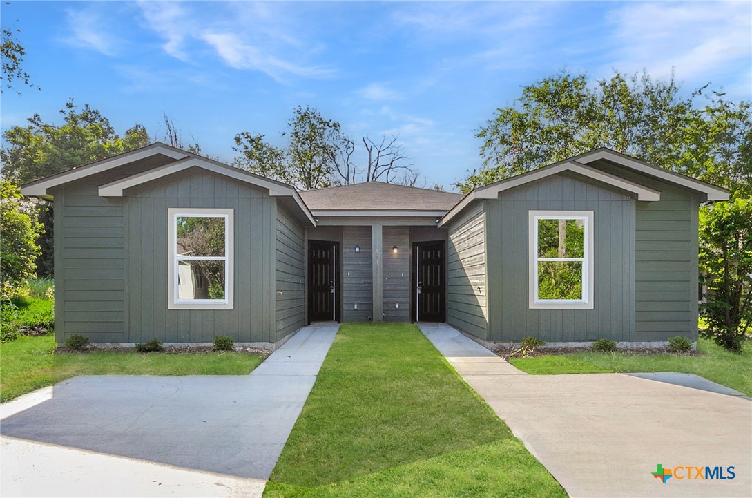 a front view of a house with a yard